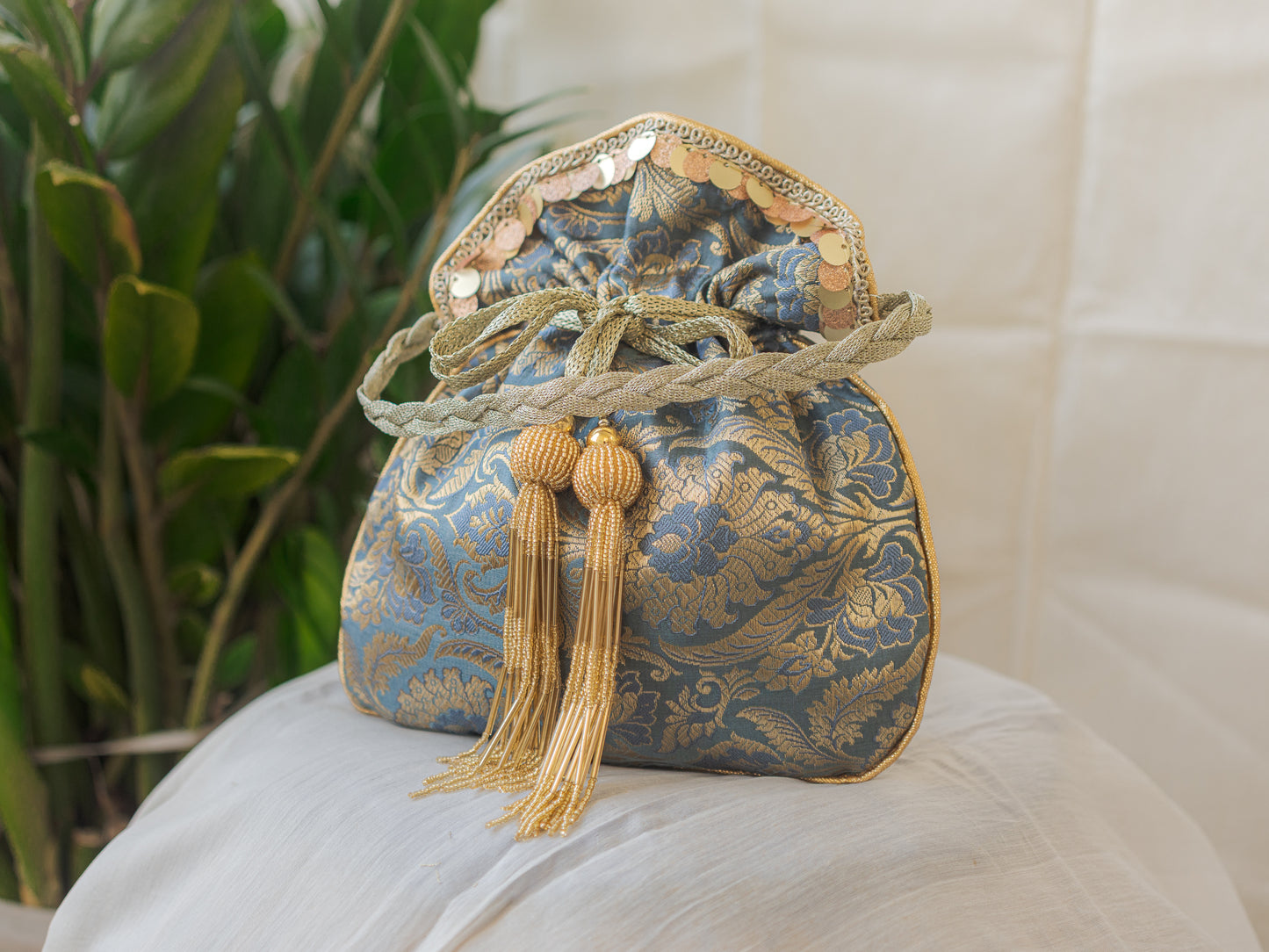 Grey & Golden Banarasi Potli With Golden Glass Tassels