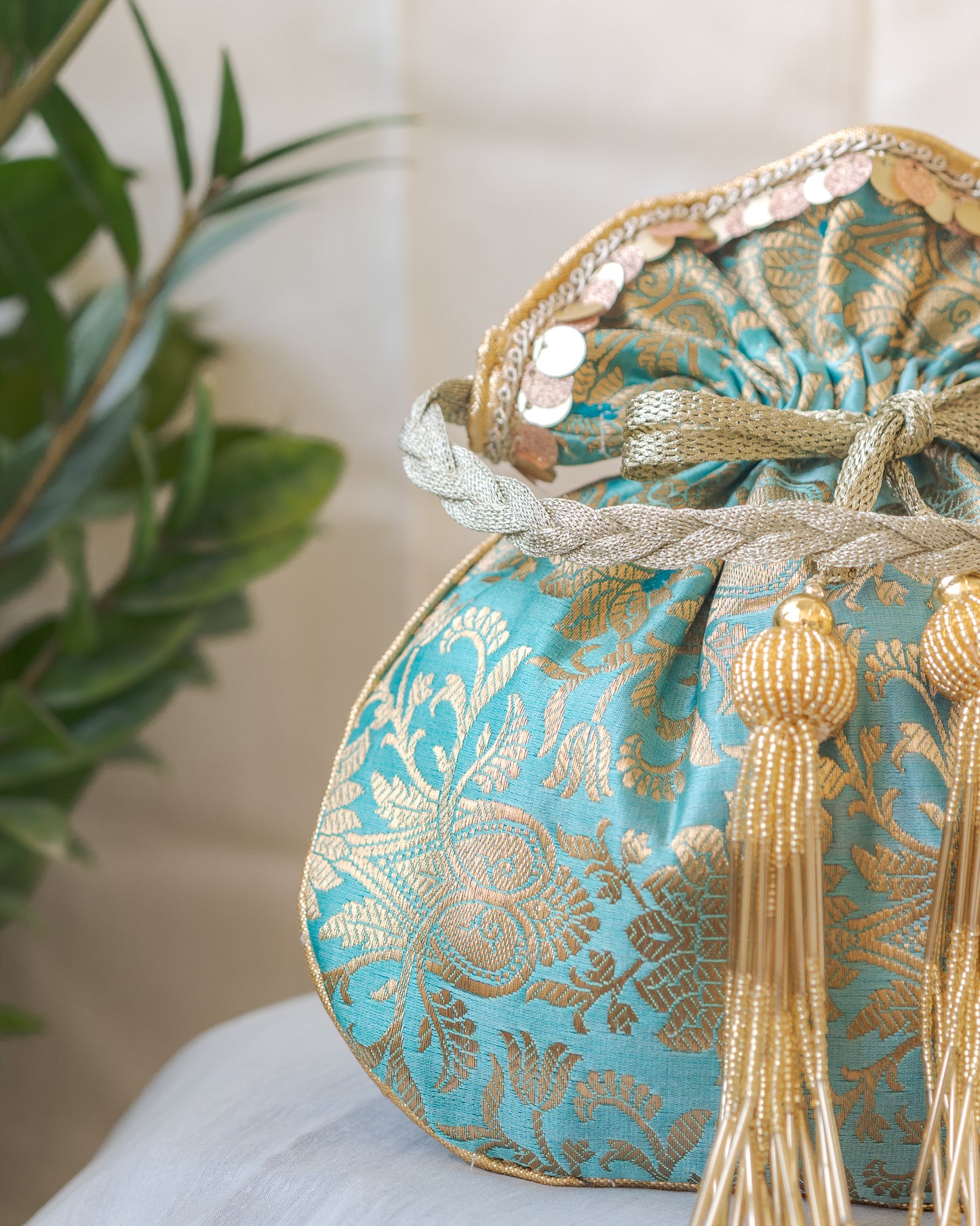 Sage Green & Golden Banarasi Potli With Glass Tassels