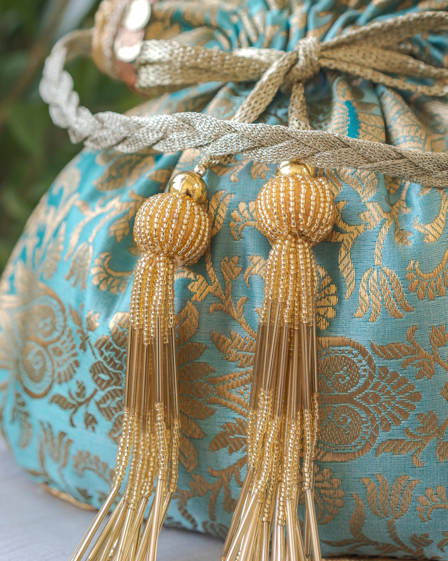 Sage Green & Golden Banarasi Potli With Glass Tassels