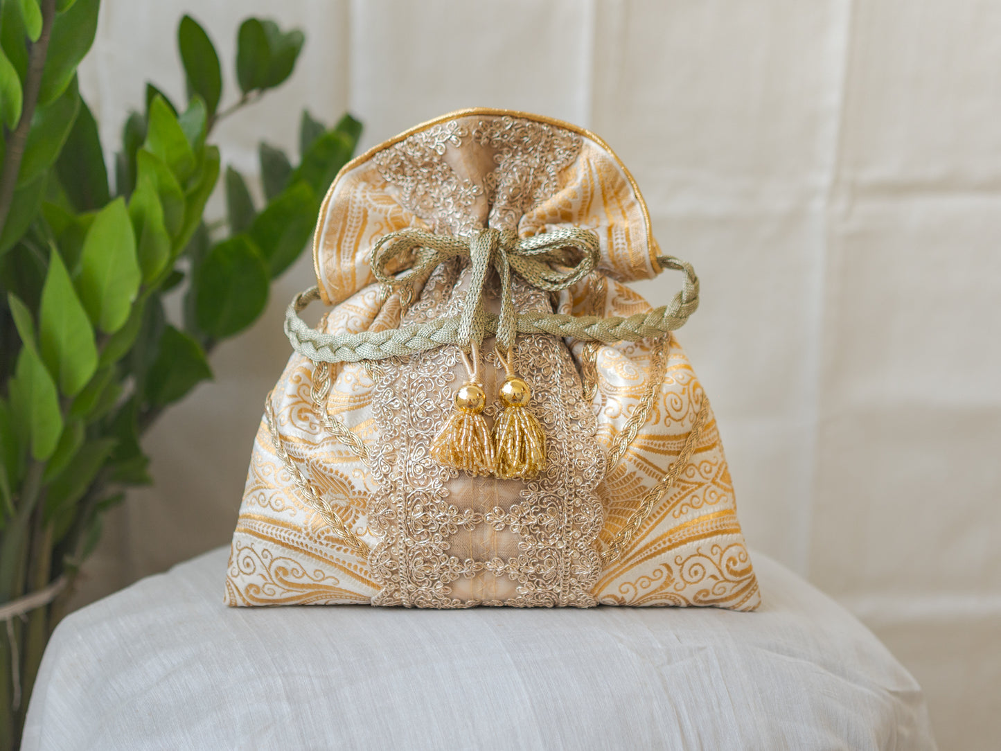 White & Golden Banarasi Potli With Broad Lace & Golden Glass Tassels
