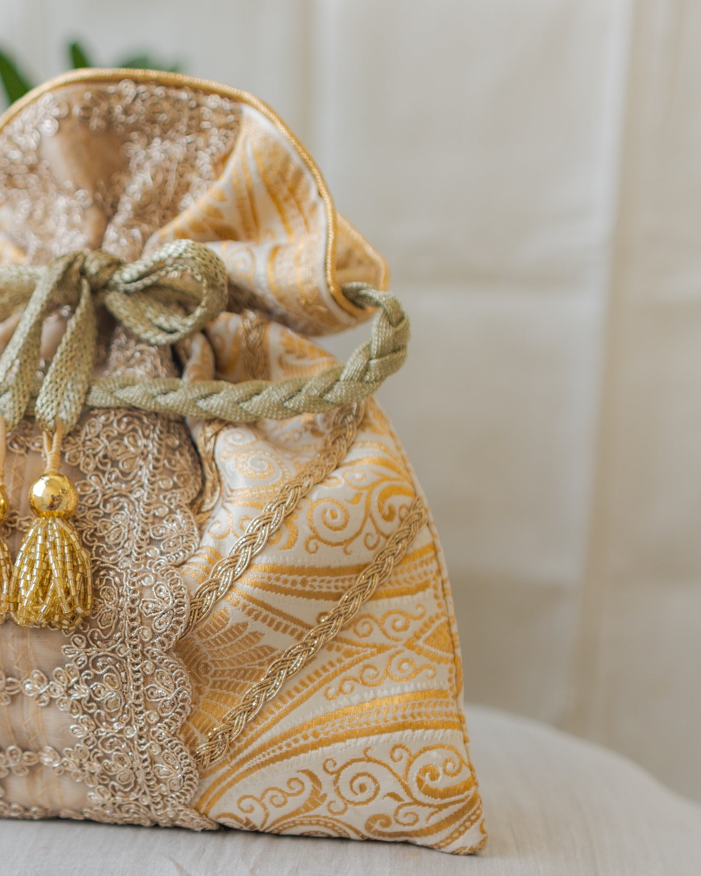 White & Golden Banarasi Potli With Broad Lace & Golden Glass Tassels