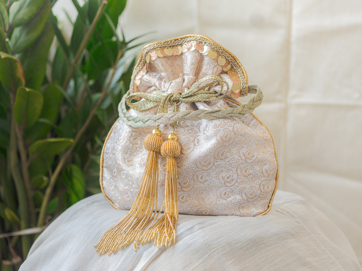 White & Golden Banarasi Potli With Golden Glass Tassels