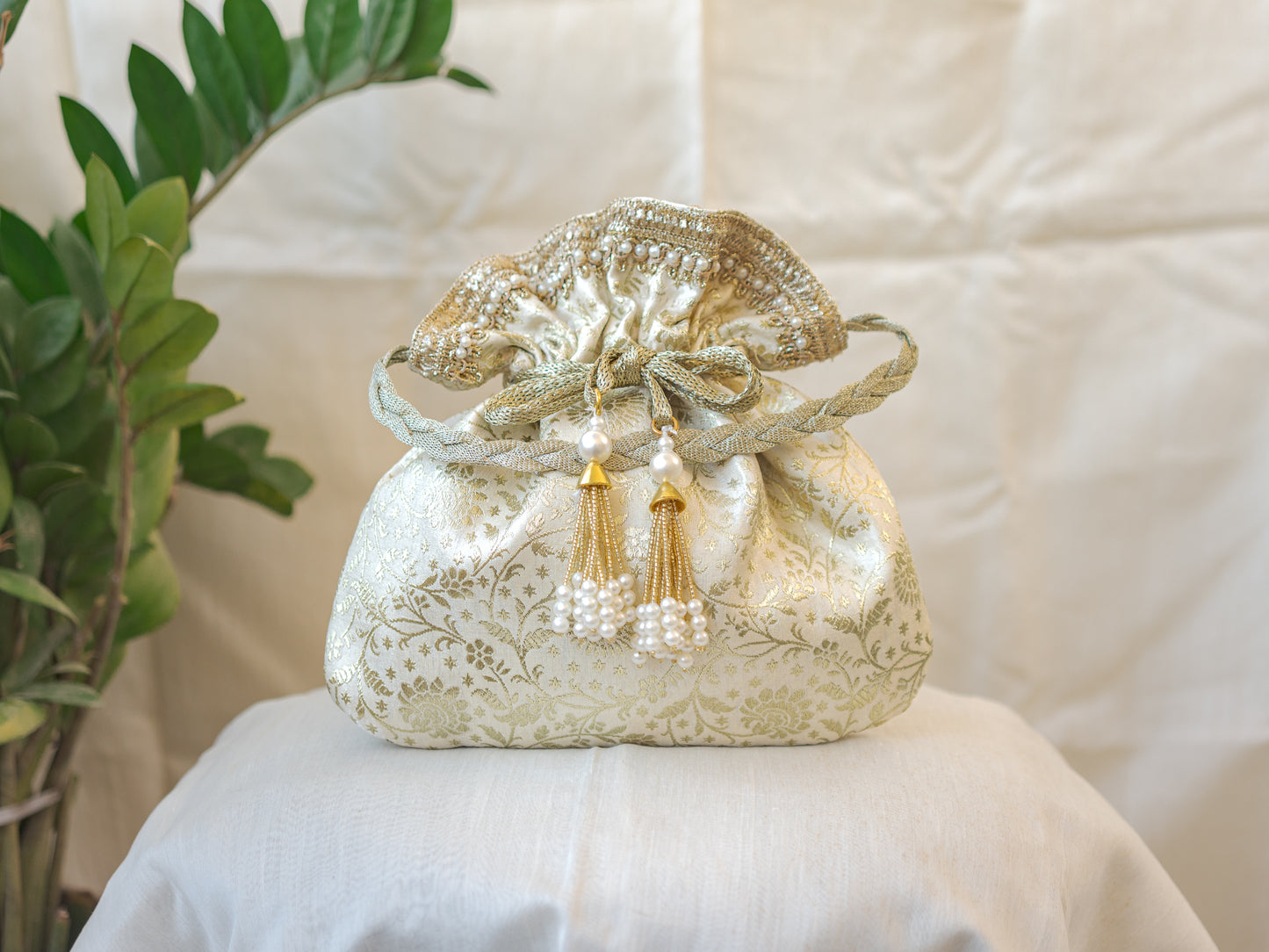 Off White and Golden Banarasi Potli With Pearl Tassels