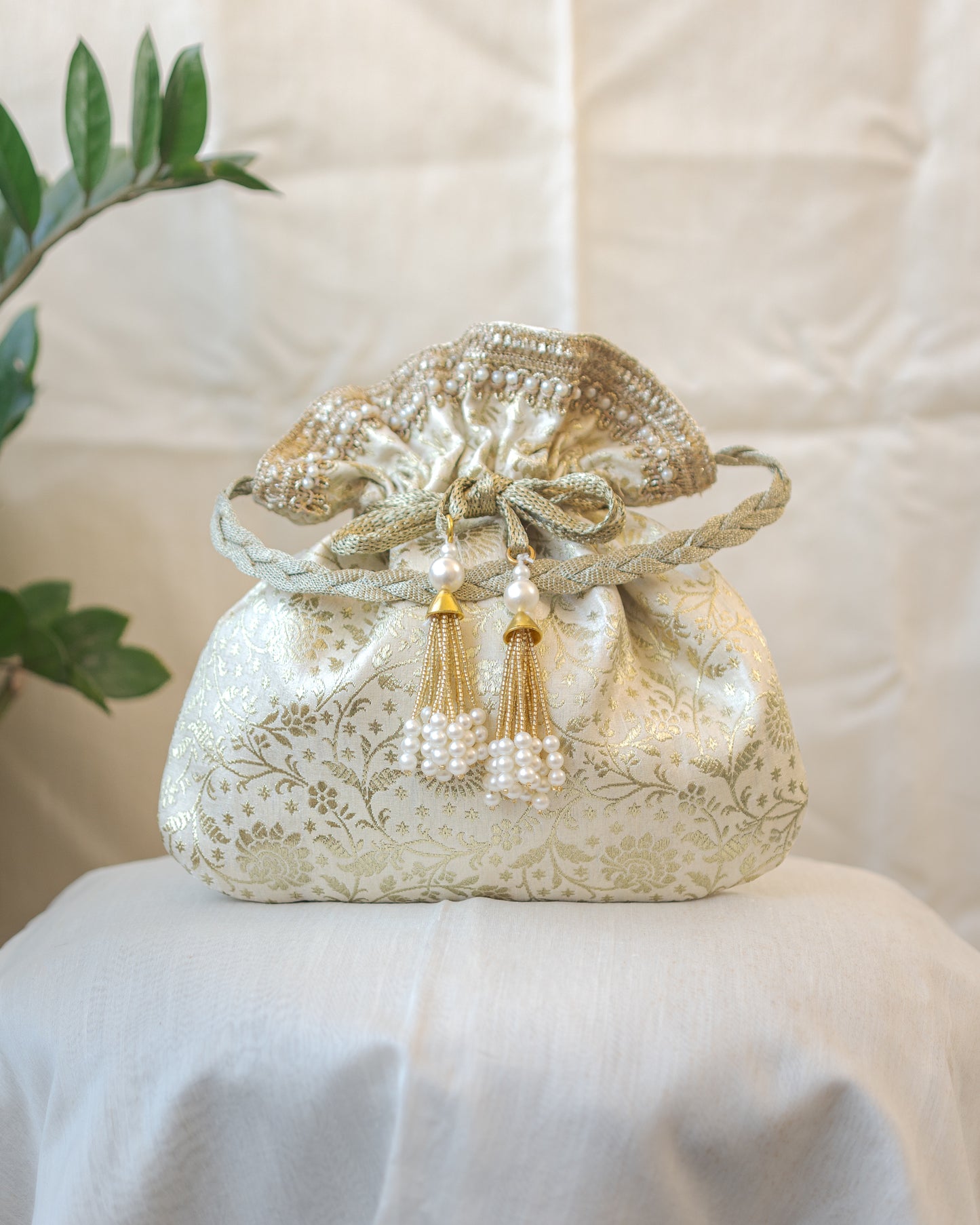 Off White and Golden Banarasi Potli With Pearl Tassels