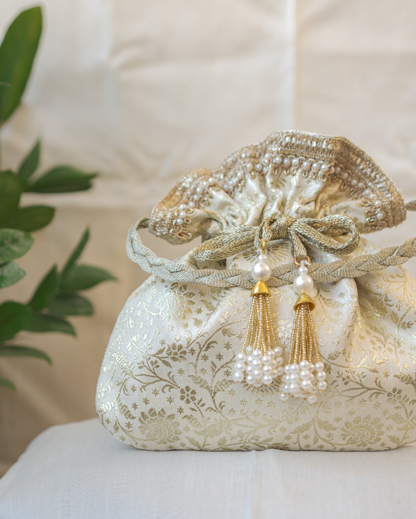Off White and Golden Banarasi Potli With Pearl Tassels