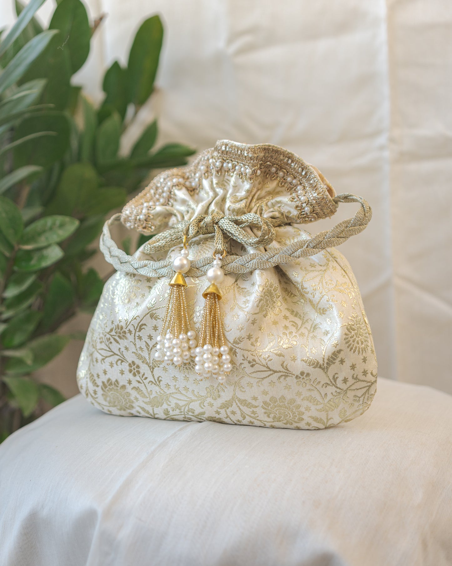 Off White and Golden Banarasi Potli With Pearl Tassels