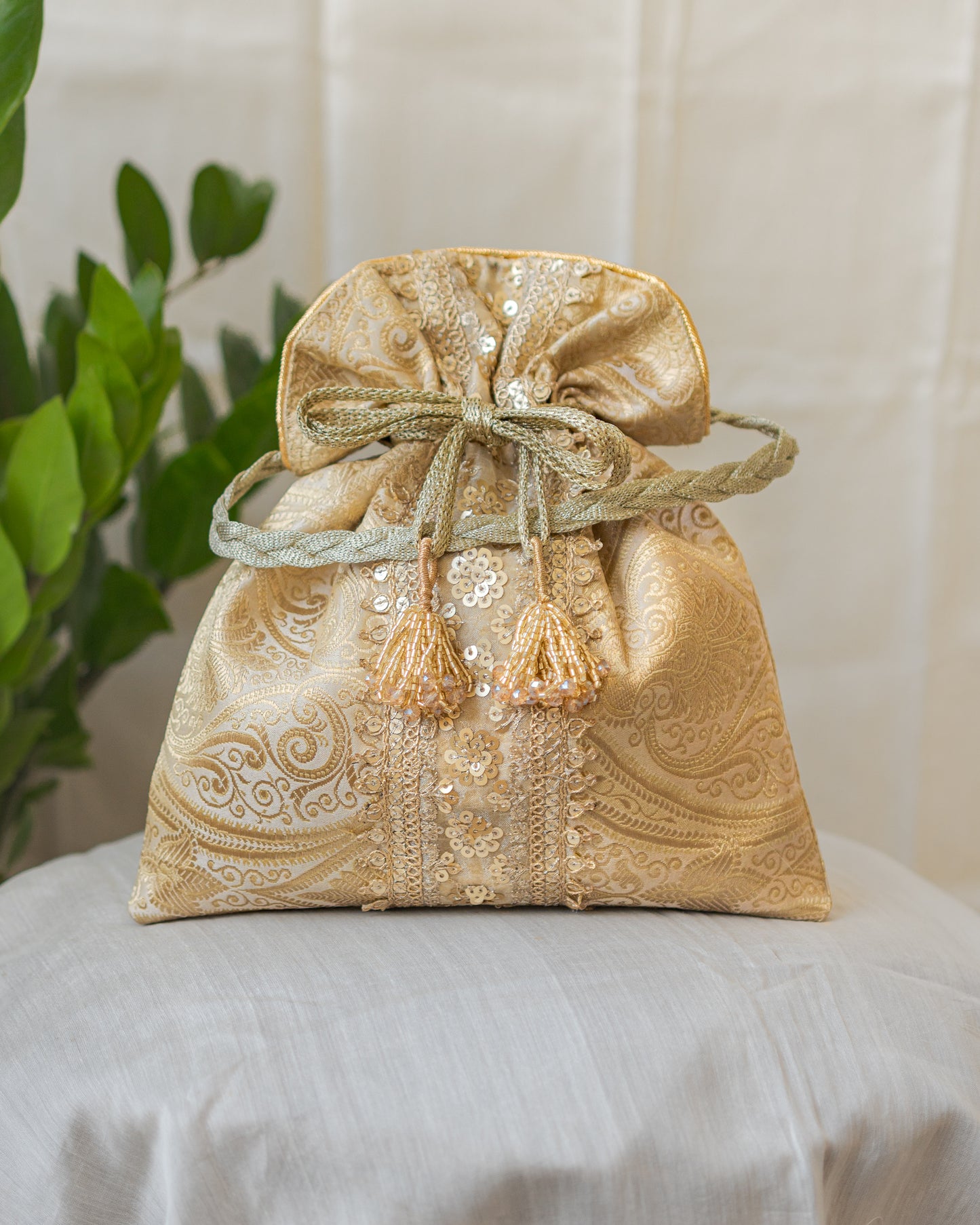 Chikoo Golden Banarasi Potli With Sequin Lace & Glass Tassels