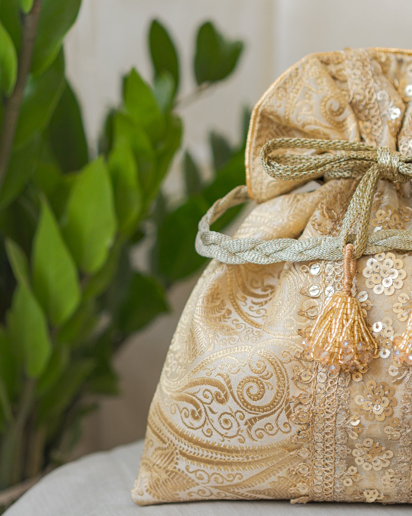 Chikoo Golden Banarasi Potli With Sequin Lace & Glass Tassels