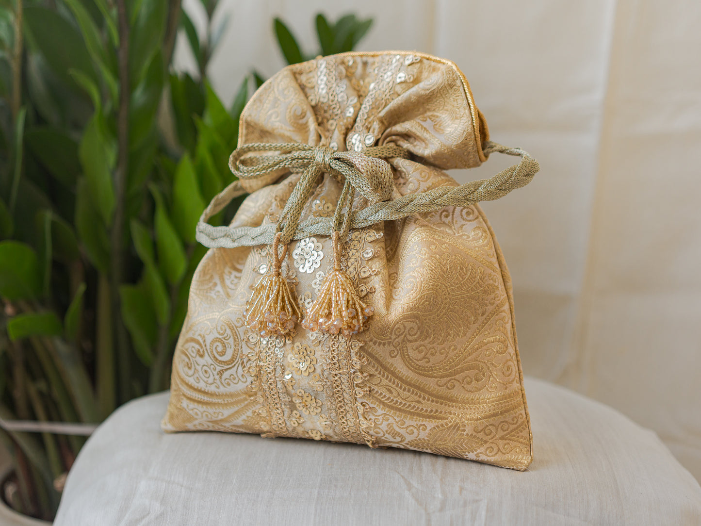 Chikoo Golden Banarasi Potli With Sequin Lace & Glass Tassels