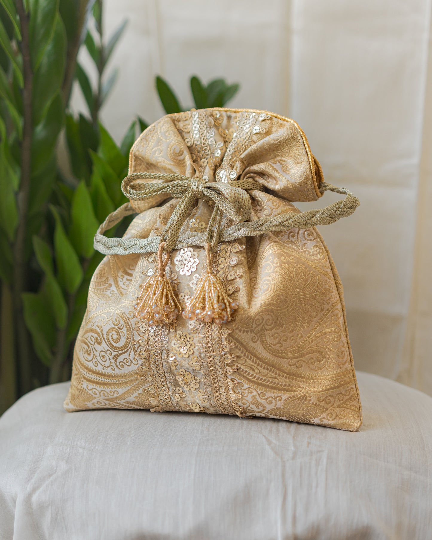 Chikoo Golden Banarasi Potli With Sequin Lace & Glass Tassels
