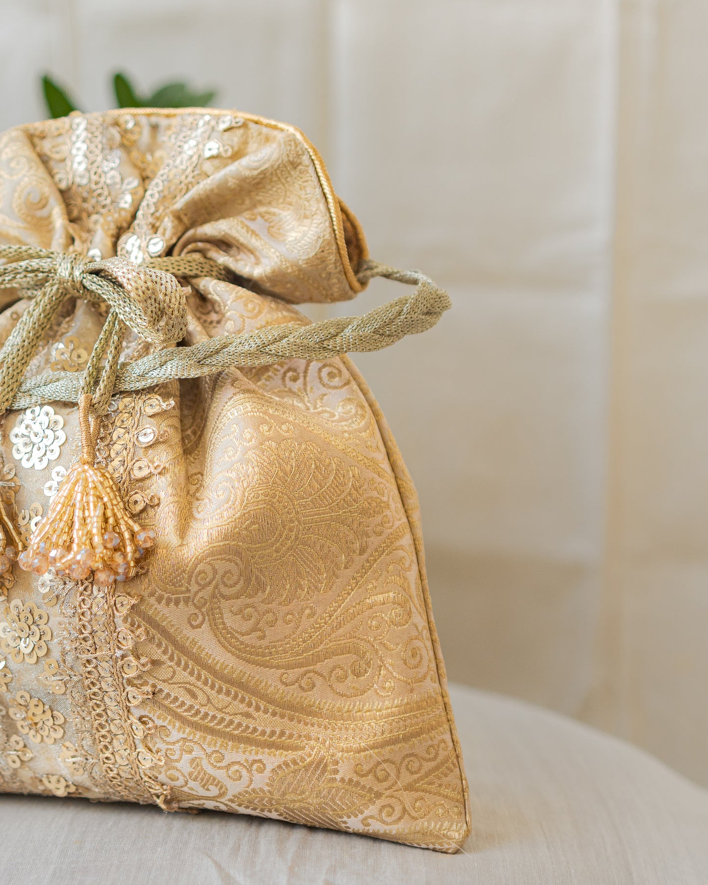 Chikoo Golden Banarasi Potli With Sequin Lace & Glass Tassels