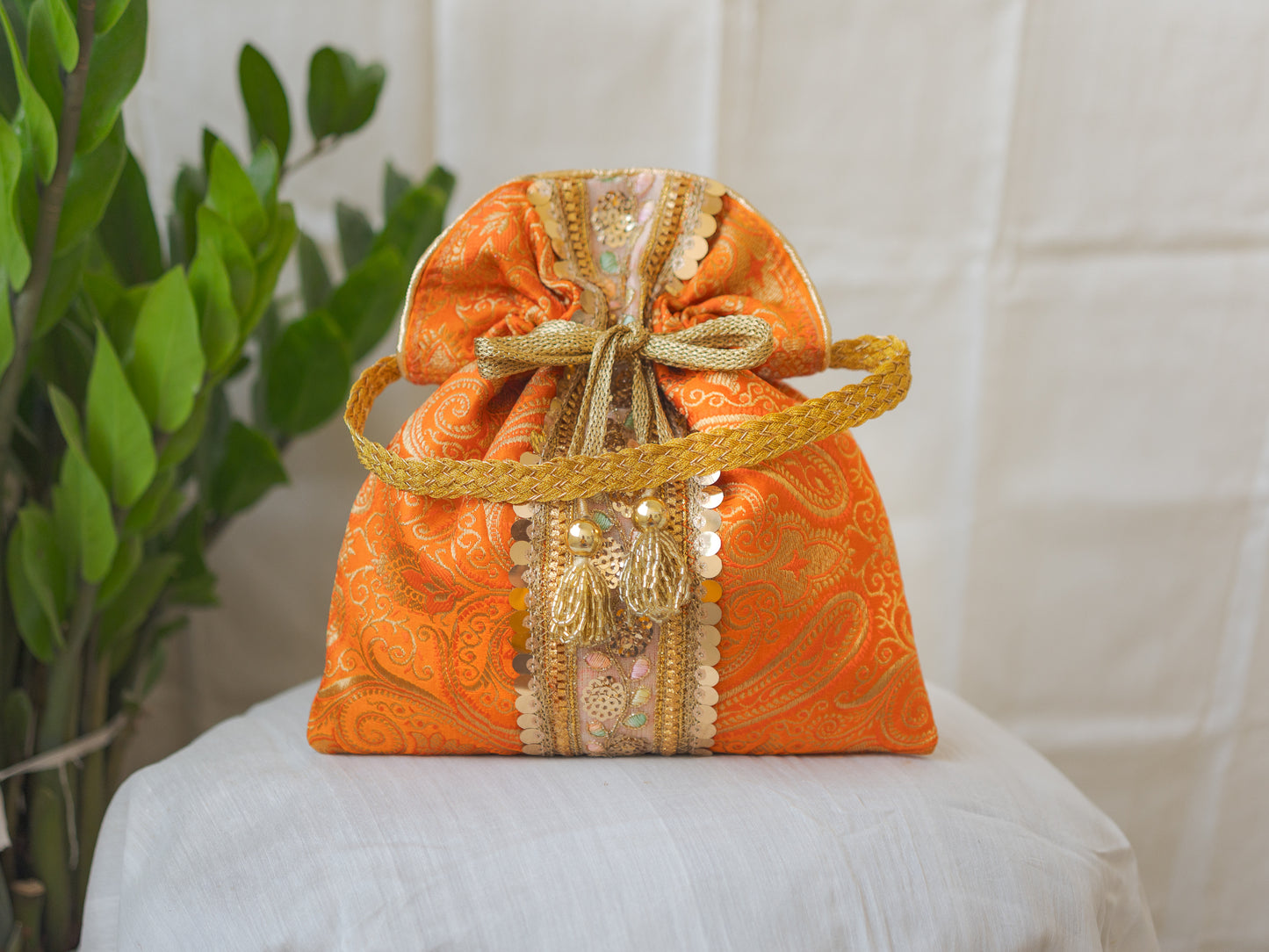 Pumpkin Orange & Golden Banarasi Potli Bag With Broad Lace