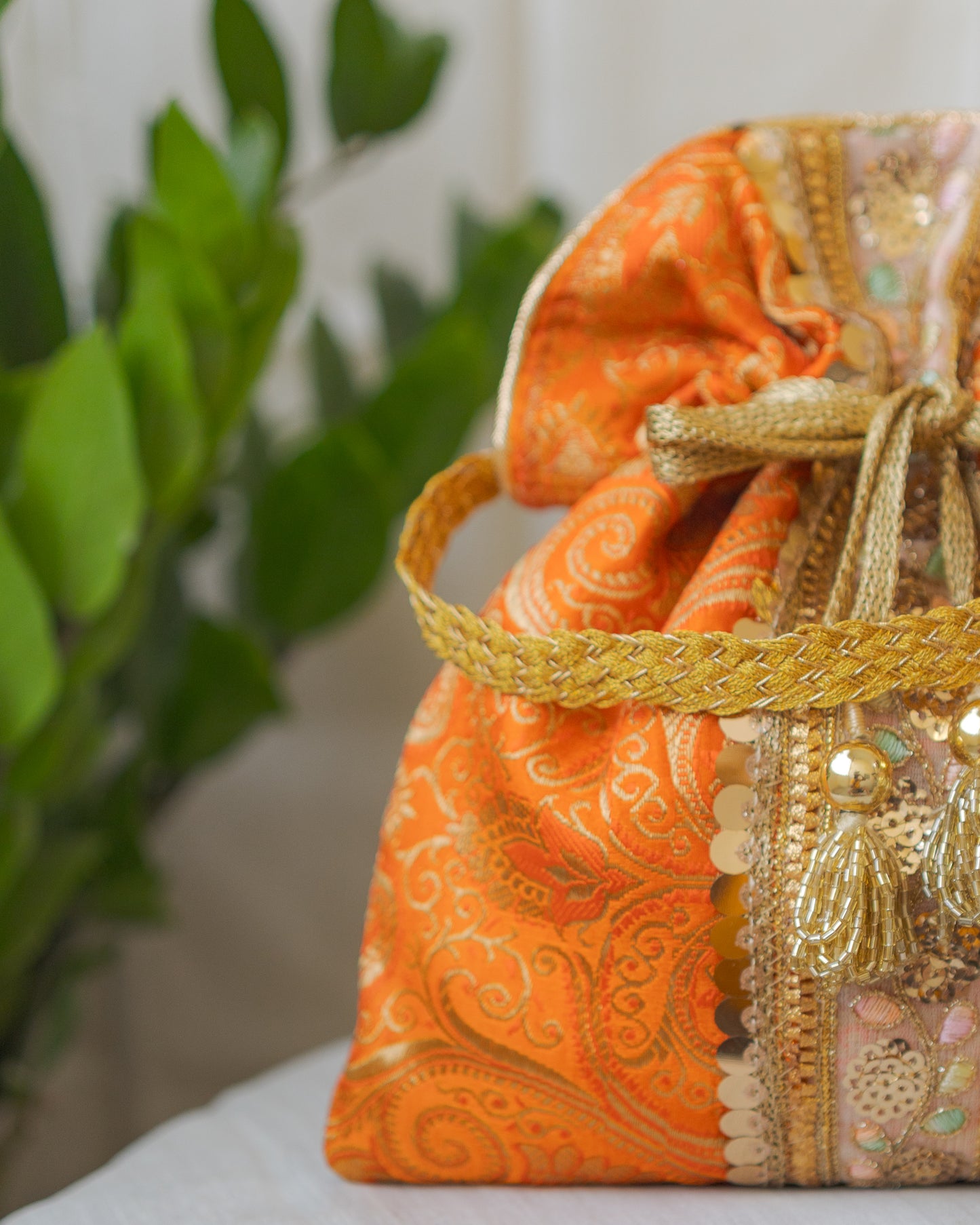Pumpkin Orange & Golden Banarasi Potli Bag With Broad Lace
