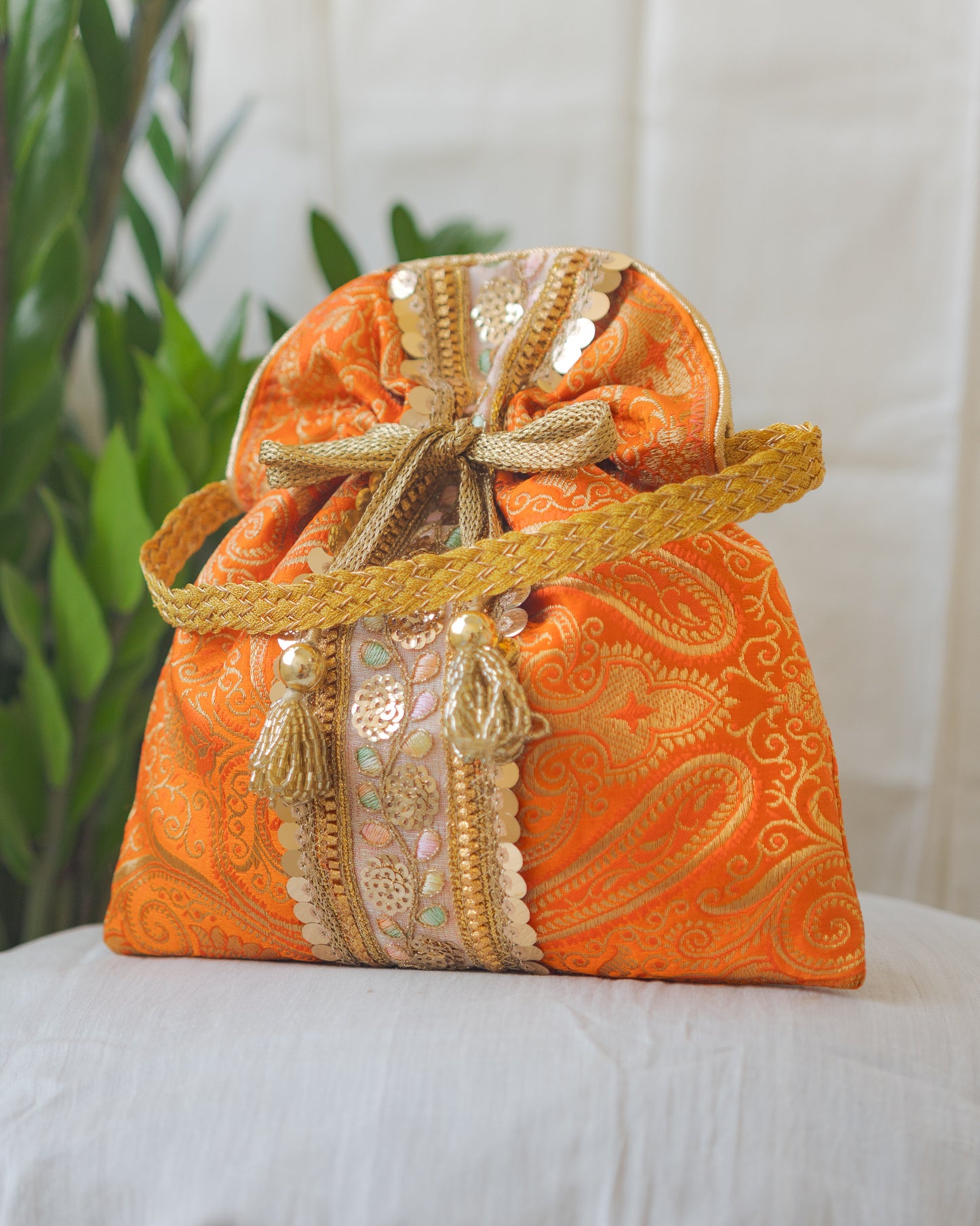 Pumpkin Orange & Golden Banarasi Potli Bag With Broad Lace