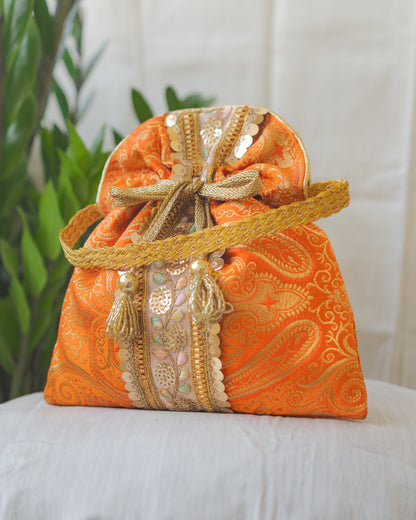 Pumpkin Orange & Golden Banarasi Potli Bag With Broad Lace