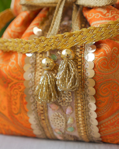 Pumpkin Orange & Golden Banarasi Potli Bag With Broad Lace