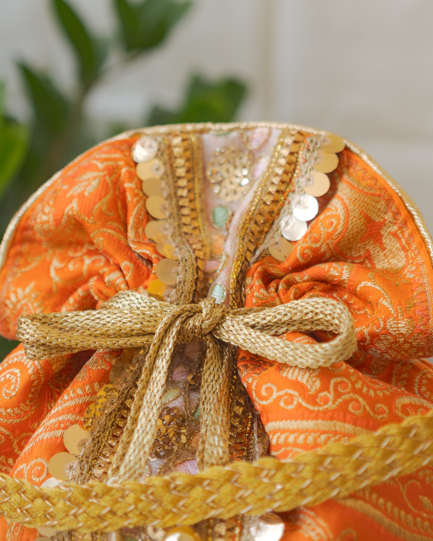 Pumpkin Orange & Golden Banarasi Potli Bag With Broad Lace