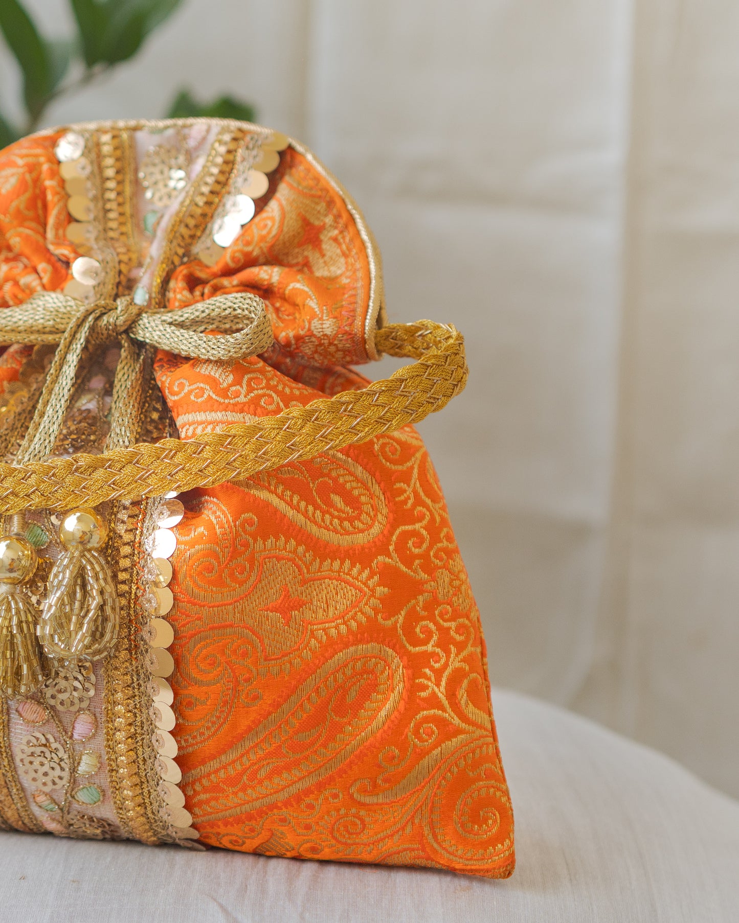 Pumpkin Orange & Golden Banarasi Potli Bag With Broad Lace