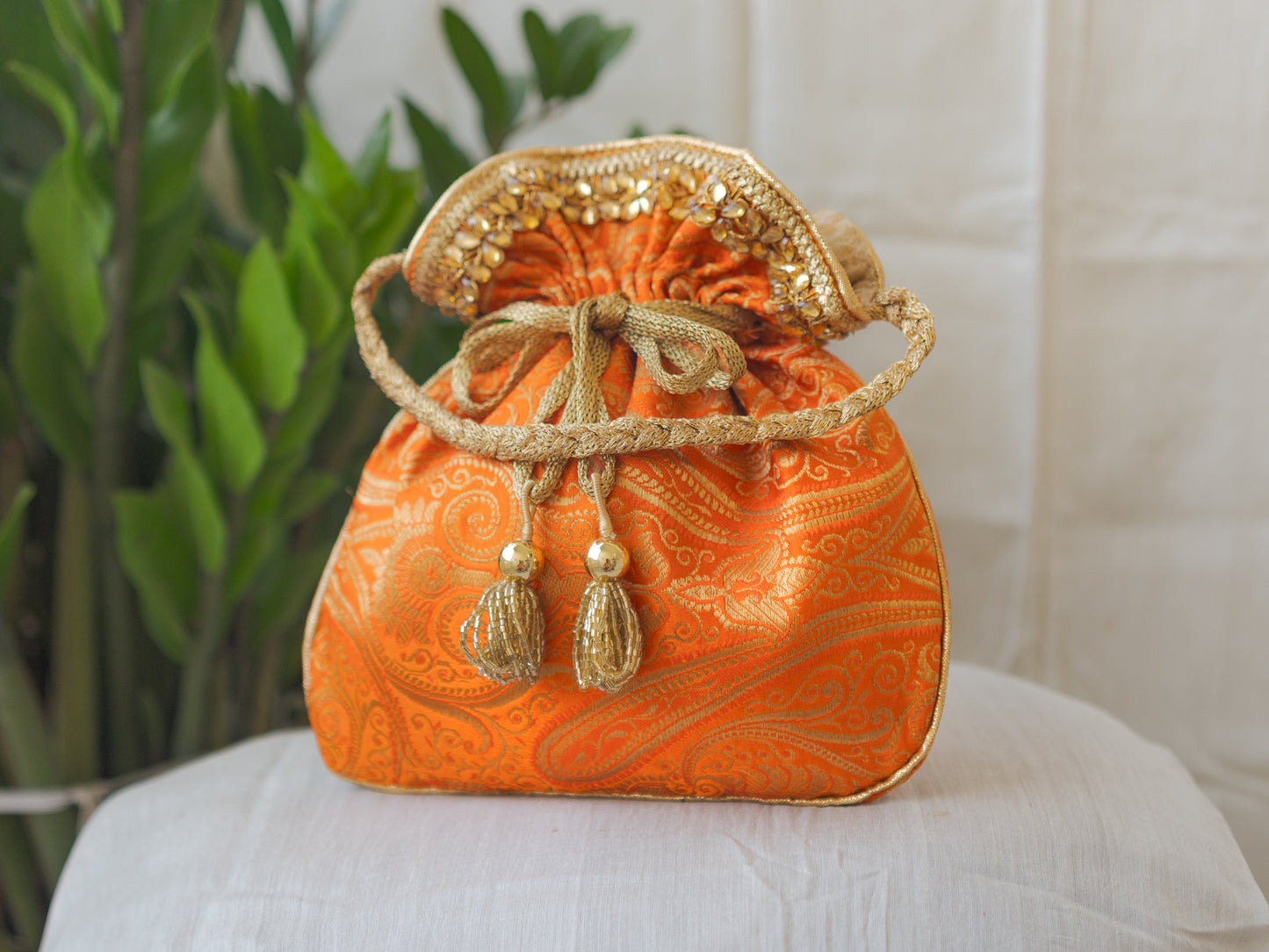 Pumpkin Orange & Golden Banarasi Potli With Glass Tassels
