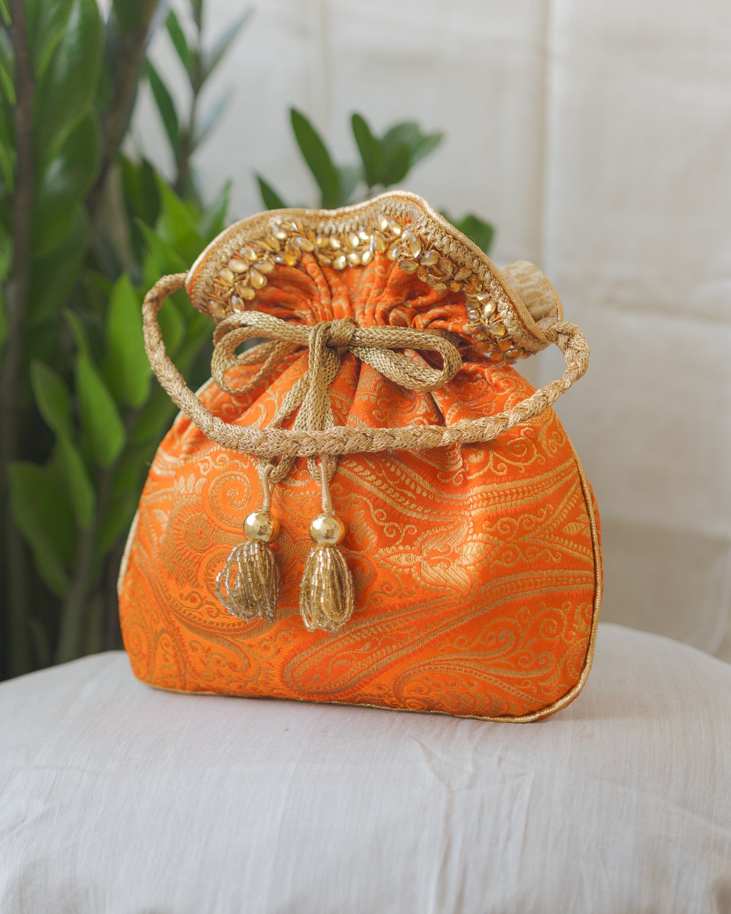 Pumpkin Orange & Golden Banarasi Potli With Glass Tassels