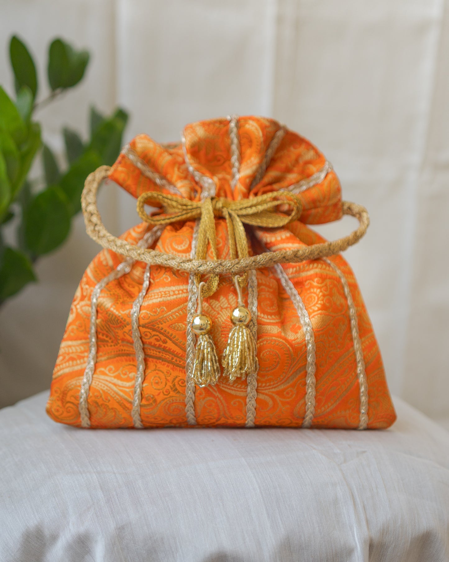 Pumpkin Orange & Golden Banarasi Potli With Glass Tassels