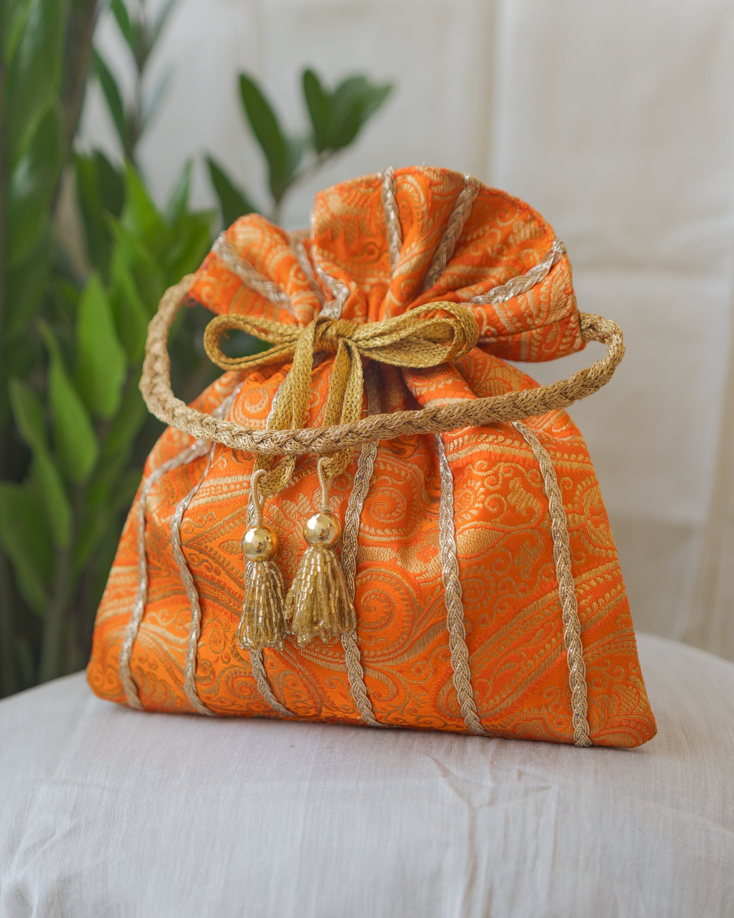 Pumpkin Orange & Golden Banarasi Potli With Glass Tassels