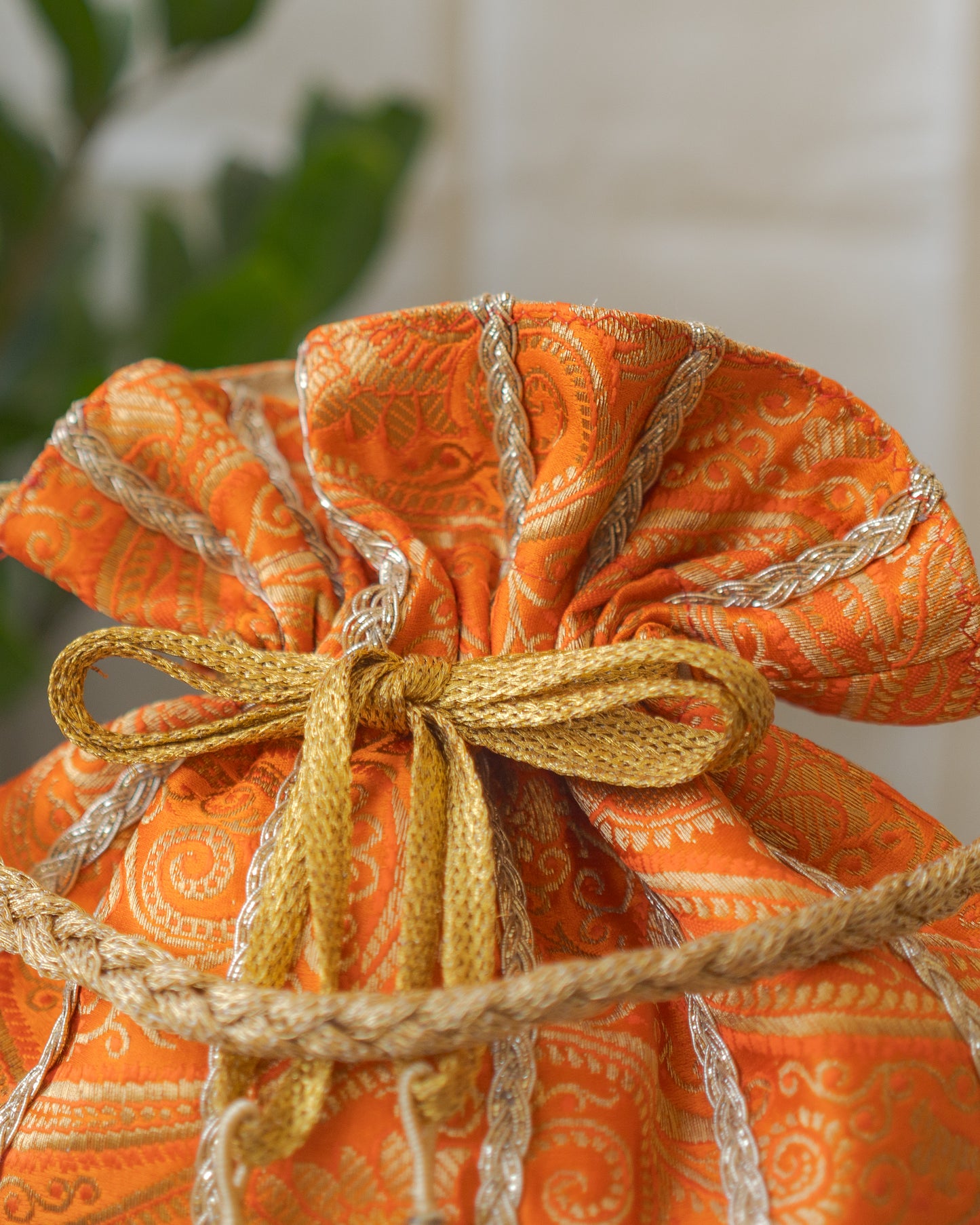 Pumpkin Orange & Golden Banarasi Potli With Glass Tassels