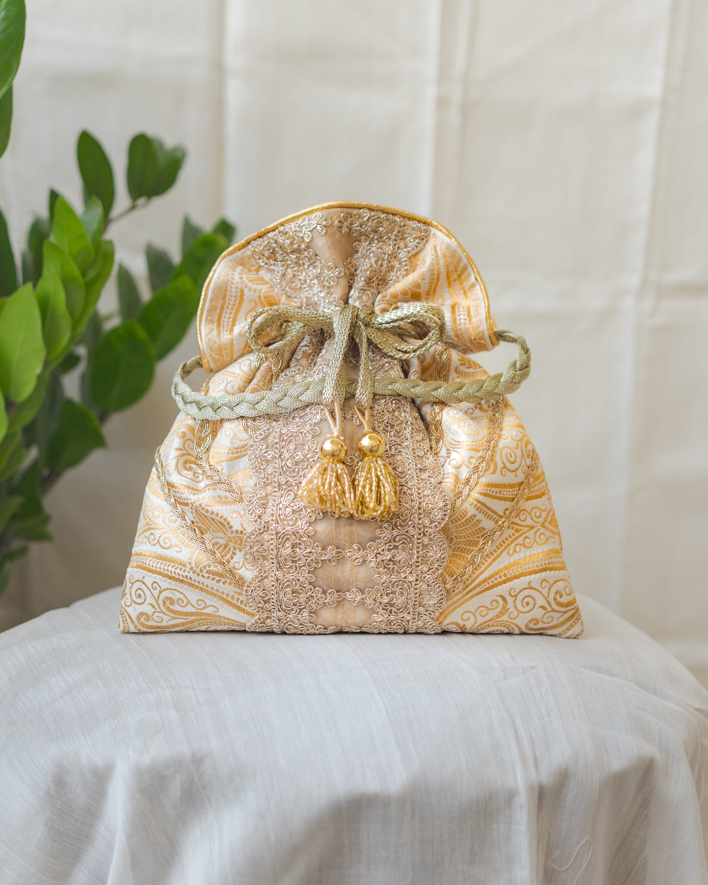 White & Golden Banarasi Potli With Broad Lace & Golden Glass Tassels