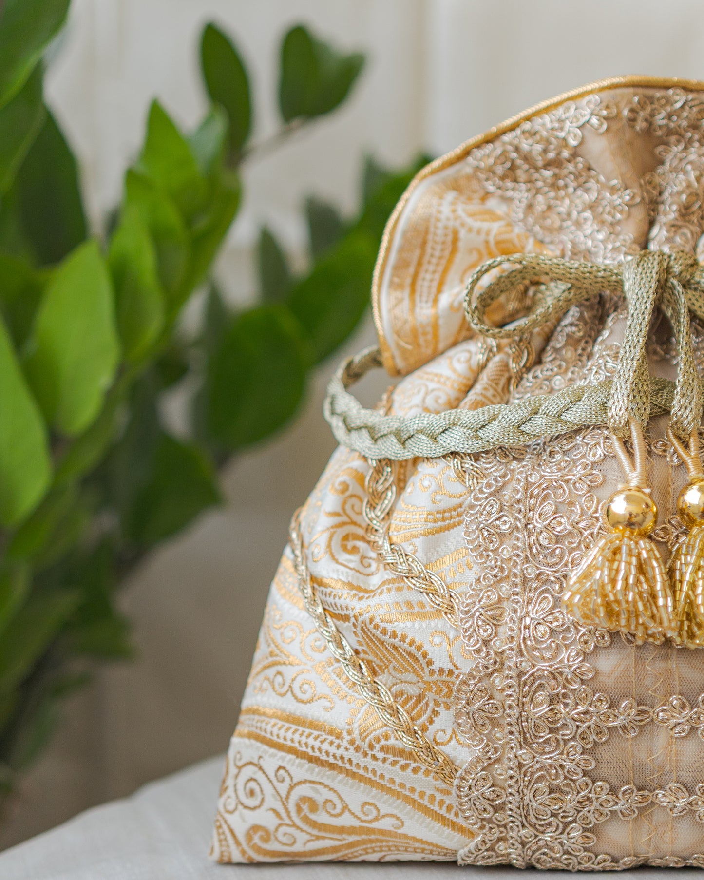 White & Golden Banarasi Potli With Broad Lace & Golden Glass Tassels