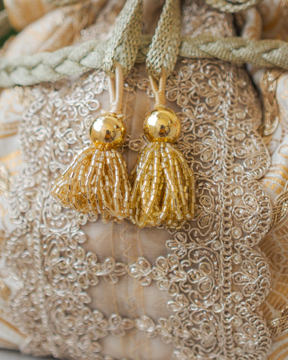 White & Golden Banarasi Potli With Broad Lace & Golden Glass Tassels
